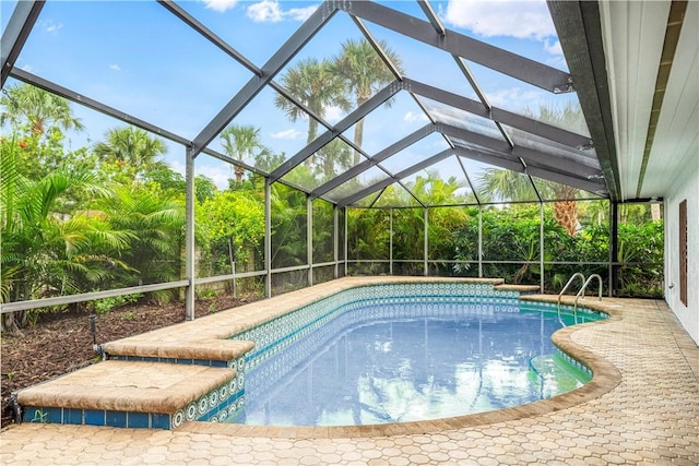 view of swimming pool featuring a lanai