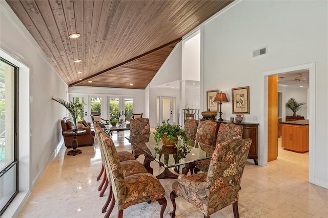 dining room with wood ceiling, ornamental molding, high vaulted ceiling, and french doors