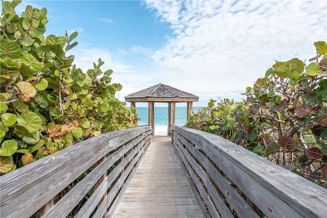 view of property's community with a water view and a gazebo