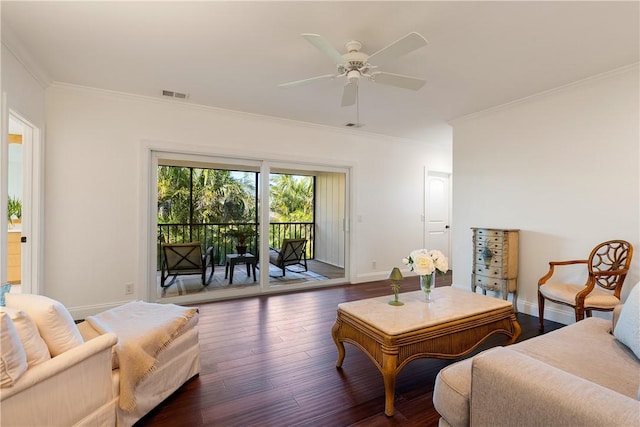 living room featuring dark wood-type flooring, ceiling fan, and ornamental molding