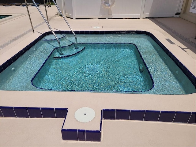 view of swimming pool featuring a community hot tub and a pool