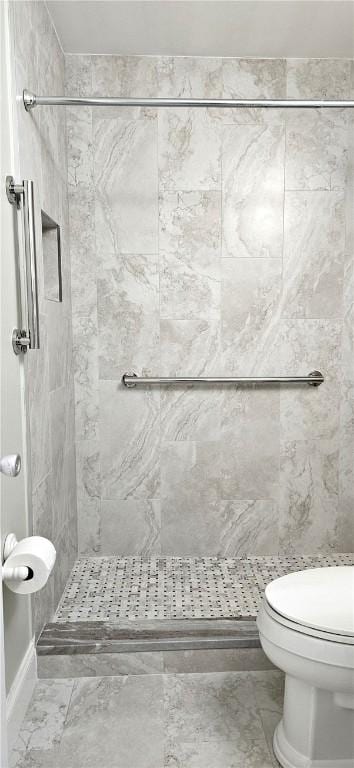 bathroom featuring a stall shower and toilet