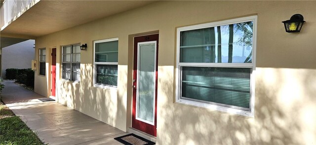 property entrance featuring stucco siding