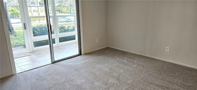 unfurnished room with baseboards, a healthy amount of sunlight, and light colored carpet