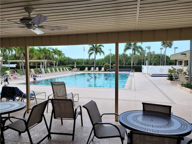 community pool featuring a ceiling fan, fence, and a patio