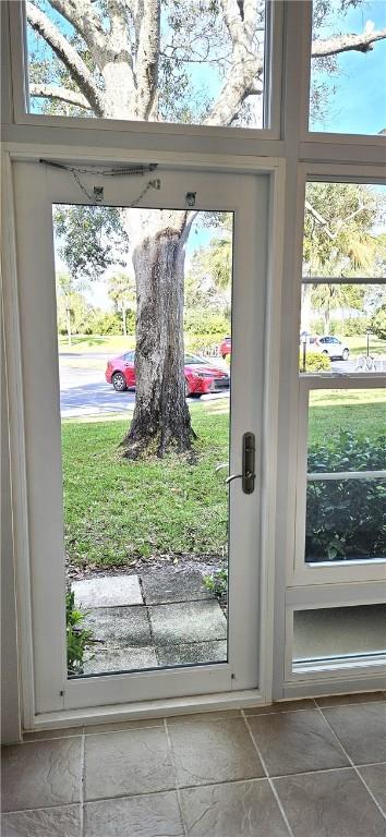 doorway with stone tile flooring