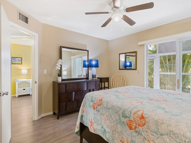 bedroom with light wood-type flooring and ceiling fan