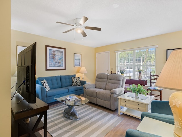 living room featuring ceiling fan and wood-type flooring