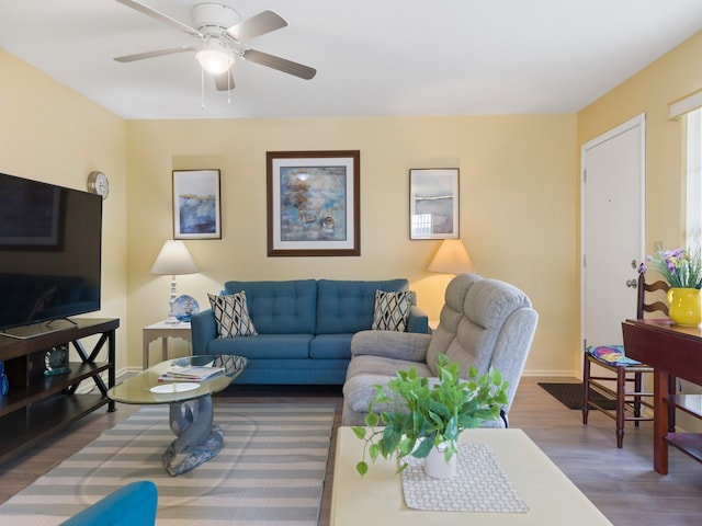 living room with dark hardwood / wood-style floors and ceiling fan