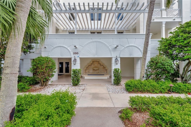 entrance to property with french doors and a balcony