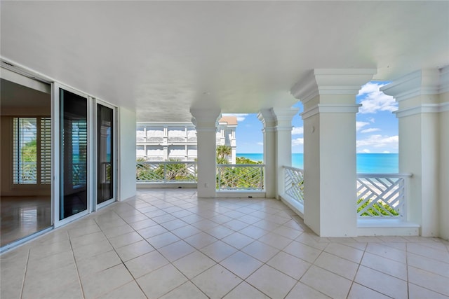 interior space with a water view and a balcony