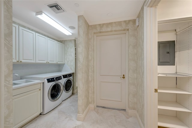 washroom with cabinets, sink, electric panel, ornamental molding, and washing machine and clothes dryer