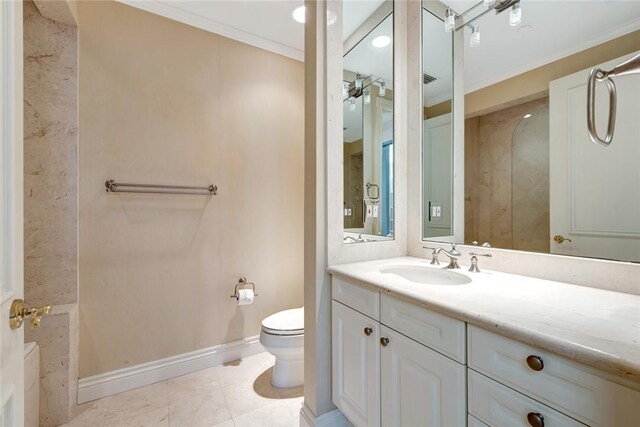 bathroom with toilet, ornamental molding, baseboards, and vanity