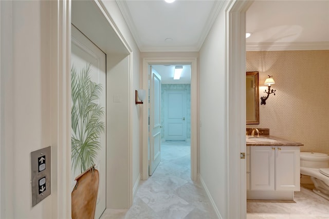 corridor featuring sink and ornamental molding