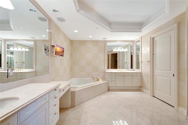 bathroom featuring ornamental molding, vanity, a relaxing tiled tub, and a tray ceiling