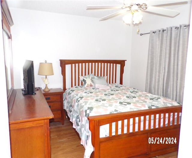 bedroom with wood finished floors and ceiling fan