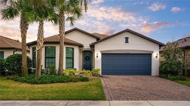 view of front of property with a yard and a garage