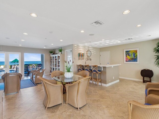 dining room featuring a water view