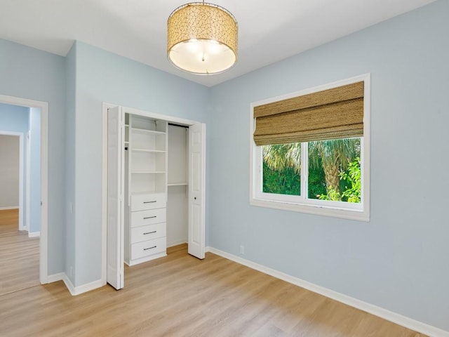 unfurnished bedroom with light hardwood / wood-style floors and a closet