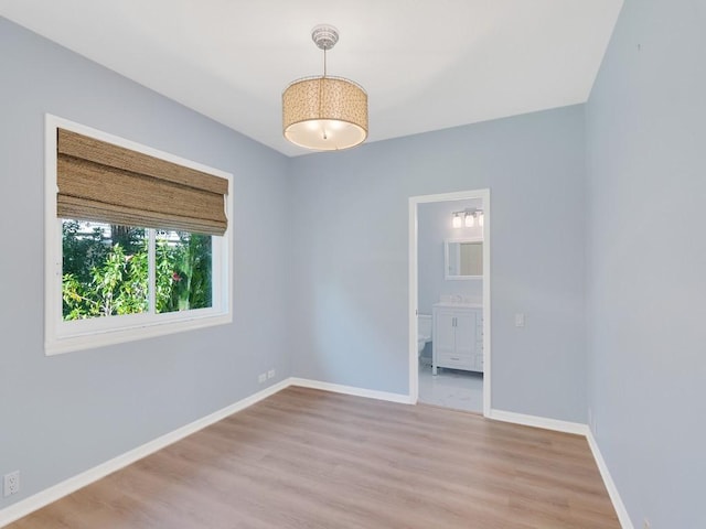 unfurnished room with sink and light wood-type flooring