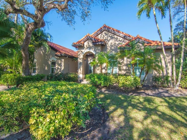 mediterranean / spanish-style home featuring a front lawn