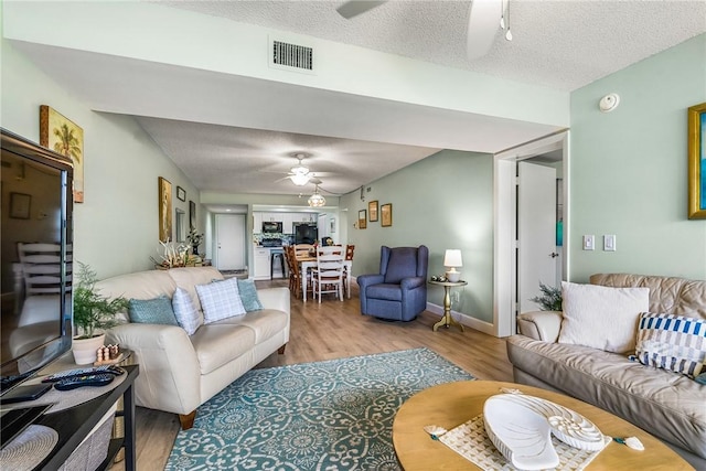 28 Plantation Dr Unit 204, Vero Beach, FL 32966 - living area featuring a ceiling fan, wood finished floors, and a textured ceiling