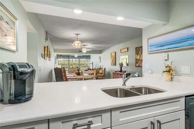 28 Plantation Dr Unit 204, Vero Beach, FL 32966 - kitchen with a sink, light countertops, a ceiling fan, a textured ceiling, and recessed lighting
