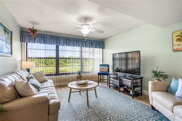 28 Plantation Dr Unit 204, Vero Beach, FL 32966 - living area with wood finished floors, ceiling fan, and a textured ceiling