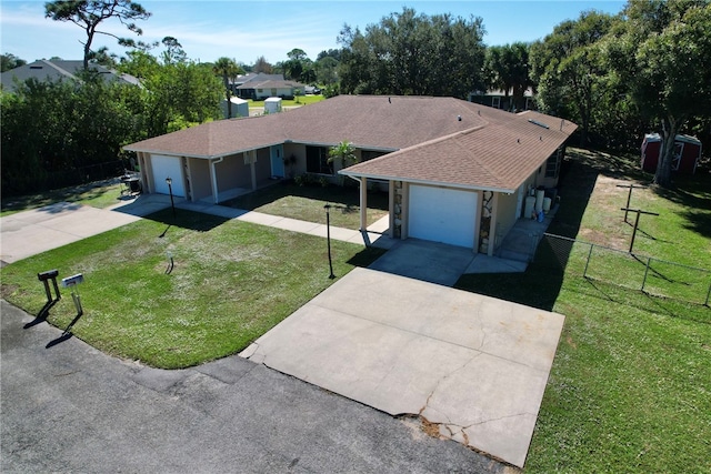 view of front of property featuring a front yard and a garage