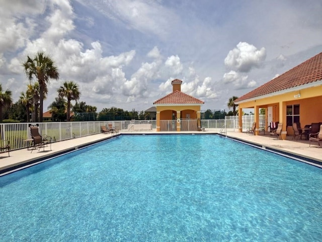 view of swimming pool featuring a patio area