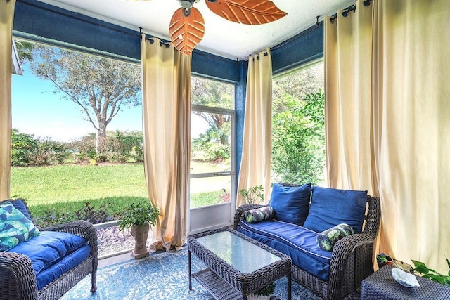 sunroom featuring ceiling fan and a healthy amount of sunlight