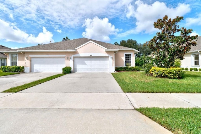 ranch-style home with a garage and a front lawn