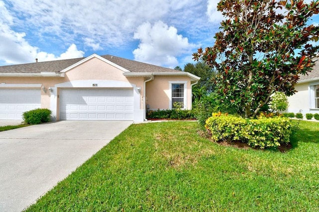 ranch-style home with a garage and a front lawn