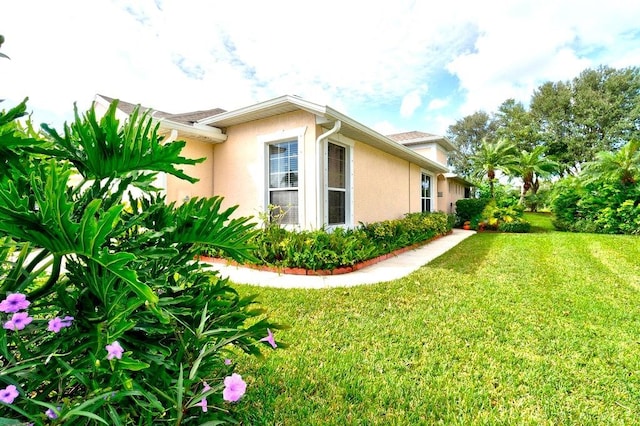 view of side of home featuring a yard