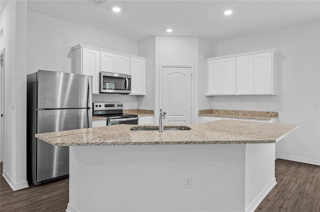 8715 98th Ct, Vero Beach, FL 32967 - kitchen featuring stainless steel appliances, a sink, dark wood finished floors, white cabinets, and recessed lighting