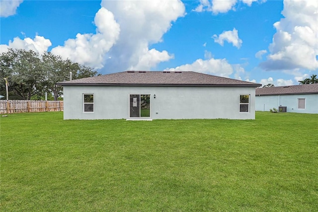 8715 98th Ct, Vero Beach, FL 32967 - back of house with stucco siding, central air condition unit, and roof with shingles
