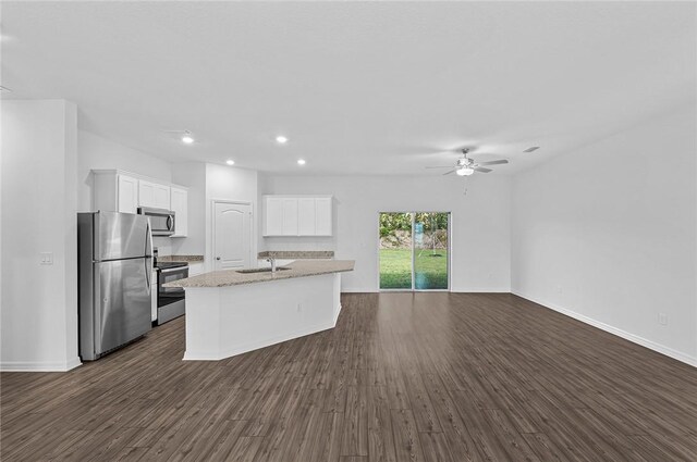 8715 98th Ct, Vero Beach, FL 32967 - kitchen featuring appliances with stainless steel finishes, a sink, white cabinetry, dark wood-type flooring, and recessed lighting