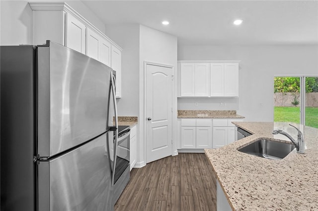 8715 98th Ct, Vero Beach, FL 32967 - kitchen with appliances with stainless steel finishes, a sink, white cabinetry, dark wood-style floors, and recessed lighting