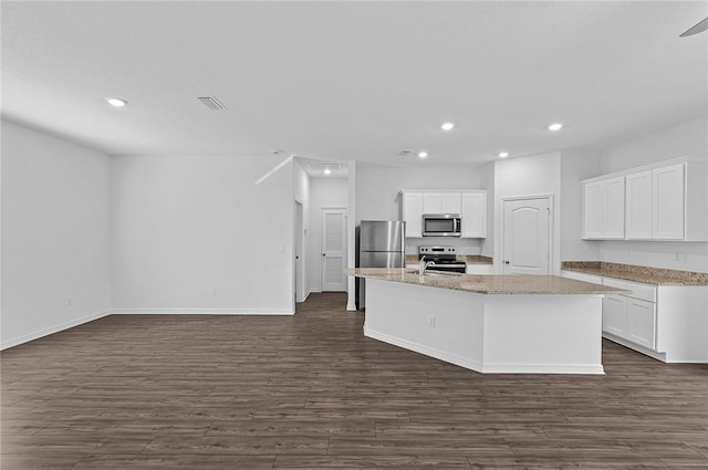 8715 98th Ct, Vero Beach, FL 32967 - kitchen with appliances with stainless steel finishes, recessed lighting, dark wood-style flooring, white cabinetry, and a center island with sink