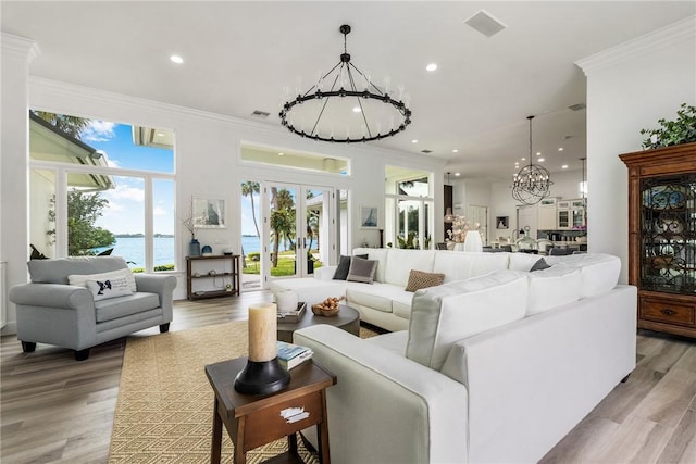 1411 E Camino Del Rio, Vero Beach, FL 32963 - living room featuring light wood finished floors, recessed lighting, ornamental molding, and a notable chandelier