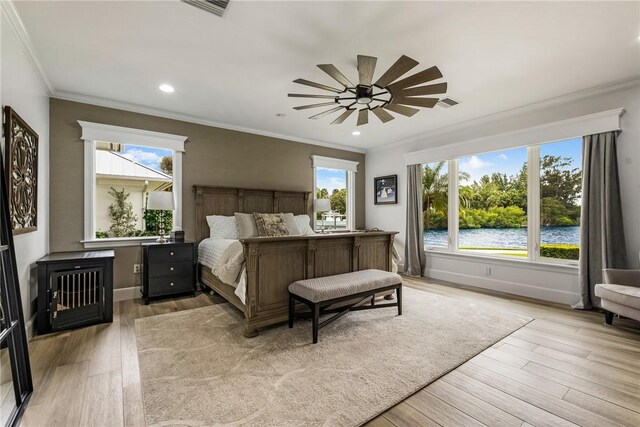 1411 E Camino Del Rio, Vero Beach, FL 32963 - bedroom with light wood finished floors, crown molding, a water view, and visible vents