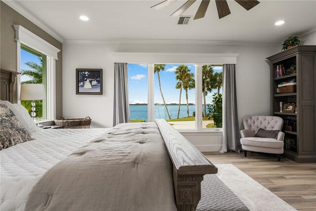 1411 E Camino Del Rio, Vero Beach, FL 32963 - bedroom with a water view, ornamental molding, recessed lighting, and light wood-style floors