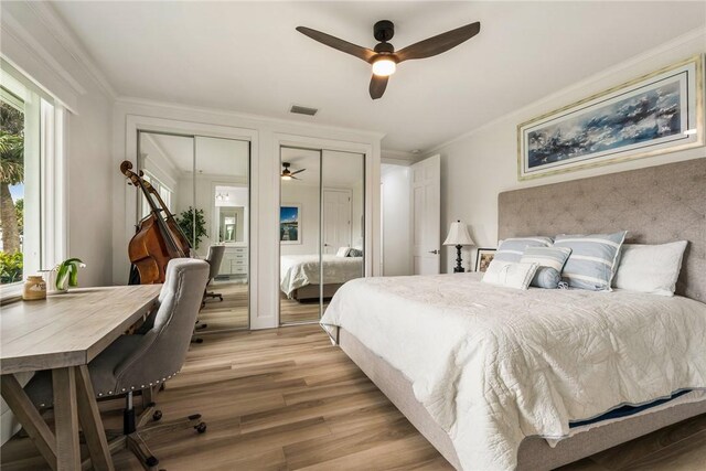 1411 E Camino Del Rio, Vero Beach, FL 32963 - bedroom featuring multiple windows, ornamental molding, visible vents, and two closets