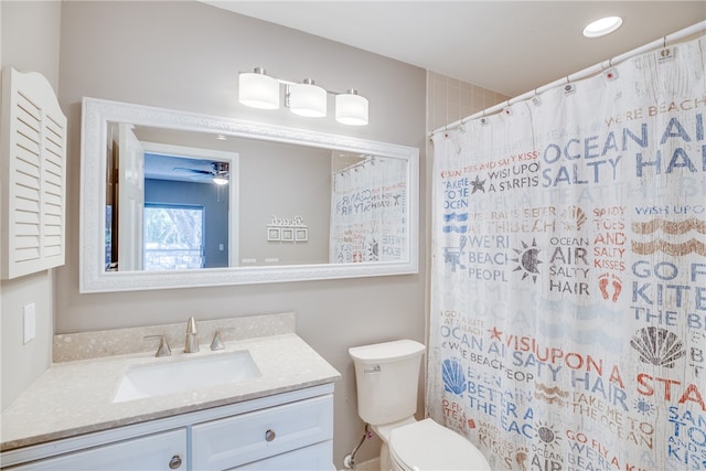 bathroom featuring walk in shower, vanity, toilet, and ceiling fan