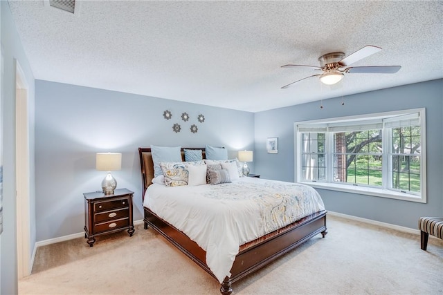 107 W Park Shores Cir Unit 28W, Vero Beach, FL 32963 - bedroom featuring light colored carpet, a textured ceiling, and ceiling fan