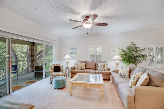 carpeted living room with ceiling fan, crown molding, and wooden ceiling