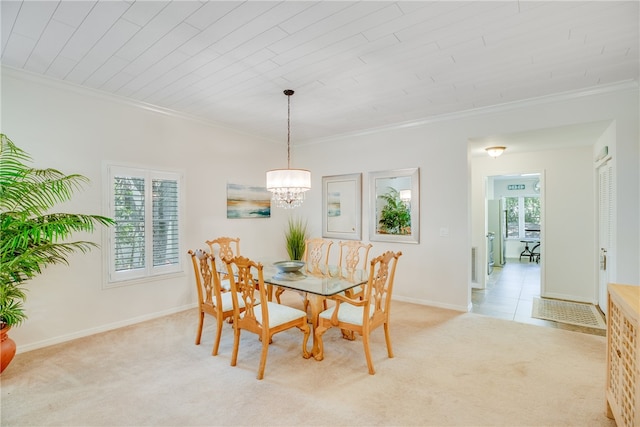 carpeted dining area featuring crown molding and a notable chandelier