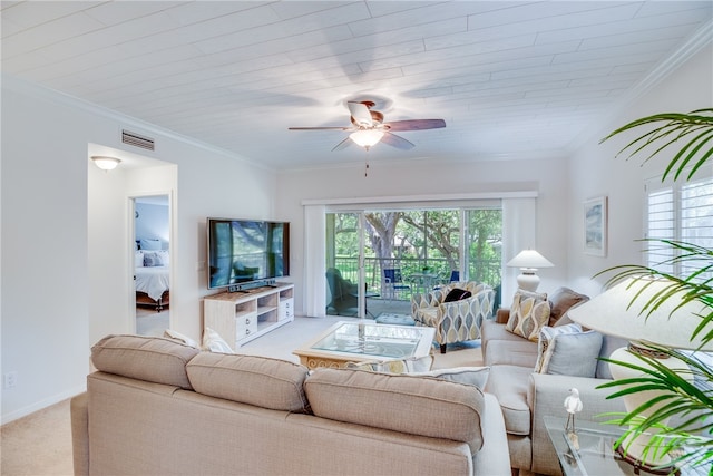carpeted living room with ornamental molding and ceiling fan