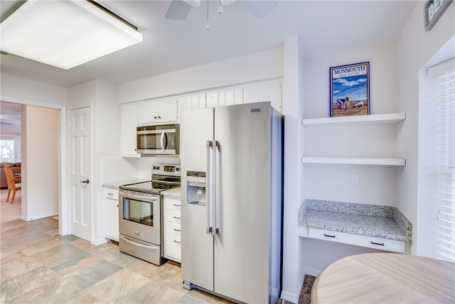 kitchen featuring white cabinetry, ceiling fan, light stone counters, and appliances with stainless steel finishes