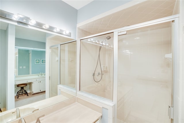 bathroom featuring a shower with door and sink